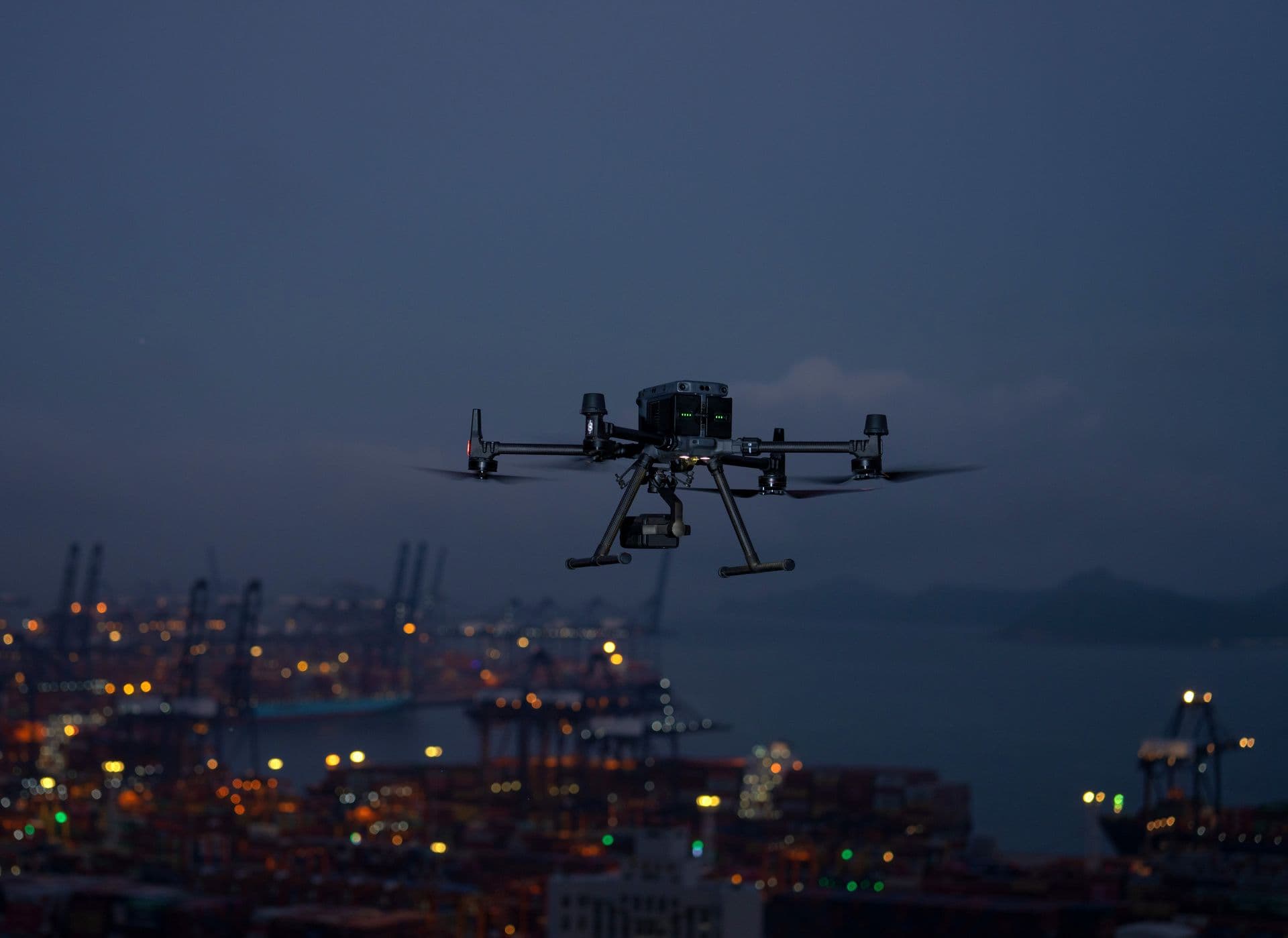 Aerial drone footage over a UK city at night